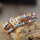 LEATHER WRAP BRACELET WITH STONES AND OM CHARM