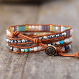 LEATHER WRAP BRACELET WITH STONES AND OM CHARM